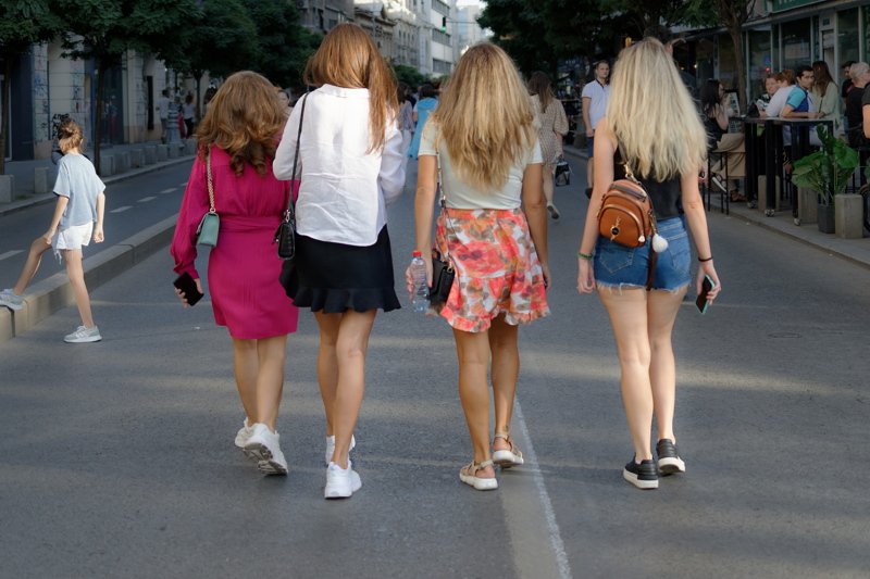 20 - People walking down a sunny city street